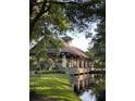 Community outdoor gazebo overlooking a pond and lush landscaping at 25879 Crossings Bluff Ln, Sorrento, FL 32776