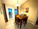 Cozy dining area with backyard views and sliding glass doors leading to the pool at 3201 Fairhaven Ave, Kissimmee, FL 34746