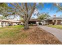 Residential home featuring a front yard and a long driveway at 3215 Roscoe Ave, Lakeland, FL 33803