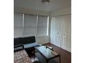 Living room with wood floors, a large window, and a comfortable seating arrangement at 5112 Conroy Rd # 17, Orlando, FL 32811