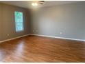 Spacious bedroom featuring hardwood floors and a bright window at 7117 Red Lantern Dr # 7117, Harmony, FL 34773