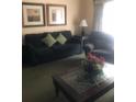 Inviting living area featuring comfortable furniture and natural light, creating a relaxing ambiance at 7697 Heritage Crossing Way # 302, Reunion, FL 34747