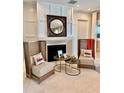 Living room with fireplace and decorative details, featuring zebra print chairs at 800 Stephens Pass Cv, Lake Mary, FL 32746