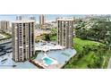 Scenic aerial view of two high-rise condos with pools and landscaping, highlighting amenities at 1 Oceans West Blvd # 3B4, Daytona Beach, FL 32118