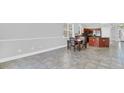 Open dining area featuring tile floors and an adjacent kitchen and breakfast bar at 1333 Darnaby Way, Orlando, FL 32824