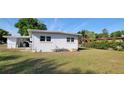 View of the home's backyard featuring the exterior, grass and an outside storage area at 1540 Avenue C Ne, Winter Haven, FL 33881