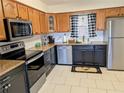 Charming kitchen featuring granite countertops and stainless steel appliances at 1640 Juno Trl # 101A, Astor, FL 32102