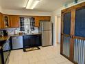 The cozy kitchen featuring granite countertops, stainless steel appliances and tile flooring at 1640 Juno Trl # 101A, Astor, FL 32102