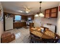 Traditional kitchen with wood cabinets, tile floor, and adjacent dining area at 1640 Juno Trl # 205B, Astor, FL 32102