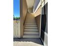 Exterior stairway with railing leading to the upper-level condo entrance at 1640 Juno Trl # 205B, Astor, FL 32102
