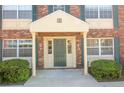 Inviting entryway of this condo with decorative columns and well-manicured shrubbery at 1920 E Edgewood Dr # D1, Lakeland, FL 33803