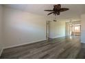 Bright living room featuring modern flooring and a ceiling fan for added comfort at 1920 E Edgewood Dr # D1, Lakeland, FL 33803