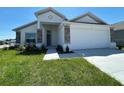 Charming single-Gathering home featuring a two-car garage, stone accents, and a well-maintained lawn at 2117 Lincoln Ln, Bartow, FL 33830