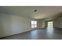 Spacious living room with tile floors and ample natural light from large windows and sliding glass doors at 2117 Lincoln Ln, Bartow, FL 33830