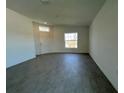 Bright living room showcasing tile floors, a large window, and a welcoming front door at 2117 Lincoln Ln, Bartow, FL 33830