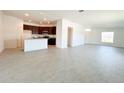 Open-concept layout with tile flooring flows into a modern kitchen with an island at 2117 Lincoln Ln, Bartow, FL 33830
