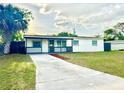Charming single-story home featuring a cozy porch and a well-maintained front yard and a long driveway at 2336 Nansen Ave, Orlando, FL 32817