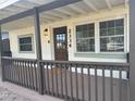 Charming front porch with sturdy railing and a welcoming front door featuring sidelight windows at 2336 Nansen Ave, Orlando, FL 32817