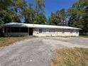 Charming single-story home with a metal roof and large front yard at 24047 Ermine Rd, Astor, FL 32102