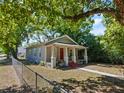 Well-maintained single-story home featuring a cozy front porch and fenced yard at 302 W Park St, Lakeland, FL 33803