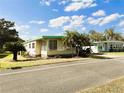 Inviting home with covered parking and a cozy screened-in porch area at 334 Palo Verde Dr, Leesburg, FL 34748