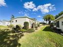 Well-maintained side yard with manicured landscaping and lush green grass at 334 Palo Verde Dr, Leesburg, FL 34748