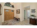 Welcoming foyer featuring a wood double door, stylish accents, decorative rug, and plenty of natural light at 365 N Spaulding Cv, Lake Mary, FL 32746