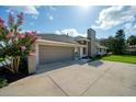 A two-car garage shows the long driveway, brick accents, and a meticulously maintained exterior at 365 N Spaulding Cv, Lake Mary, FL 32746