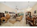 An elegant living room boasts marble floors, unique furnishings, and access to the lanai at 365 N Spaulding Cv, Lake Mary, FL 32746