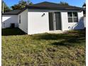 An angle of the backyard with large sliding glass door entrance and a window at 4420 W Gore Ave, Orlando,, FL 32811