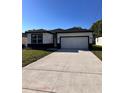 Front exterior view of single-Gathering home with two car garage at 4420 W Gore Ave, Orlando,, FL 32811