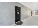 Inviting front door with wreath, welcome mat, and visible unit number at 5526 P G A Blvd # 4911, Orlando, FL 32839
