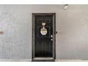 A welcoming condo front door with decorative wreath and secure entry at 5526 P G A Blvd # 4911, Orlando, FL 32839
