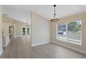 Dining and Living area with hardwood floors, neutral walls and large windows to let in natural light at 9324 Pecky Cypress Way, Orlando, FL 32836