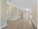 Open-concept living space featuring hardwood floors, neutral walls and archways to the rest of the home at 9324 Pecky Cypress Way, Orlando, FL 32836
