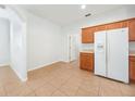 Bright kitchen with white appliances and wood cabinets and adjacent eat in area at 9651 Old Marsh Ct, Orlando, FL 32832