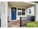 Inviting front porch with brick flooring and black metal railing at 9790 Amber Chestnut Way, Winter Garden, FL 34787