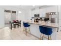 Modern kitchen featuring a center island with bar seating and white cabinets at 9790 Amber Chestnut Way, Winter Garden, FL 34787
