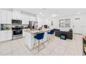 Open-concept kitchen with white cabinetry, granite countertops, and stainless steel appliances at 9790 Amber Chestnut Way, Winter Garden, FL 34787