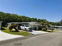 Nice single-story home with well-kept landscaping, a carport, and an inviting entrance at 106 Palo Verde Dr, Leesburg, FL 34748