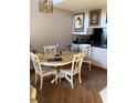 A view of dining room with a round table, seating four, on wood flooring at 1104 Illinois Ave, St Cloud, FL 34769