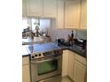 A close up view of the kitchen featuring stainless steel appliances and tile flooring at 1104 Illinois Ave, St Cloud, FL 34769