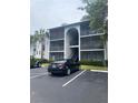 Condo exterior with multi-level screened balconies and parking area at 1134 S Pine Ridge Cir # 34, Sanford, FL 32773