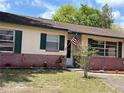 Inviting home featuring an American flag, manicured flower beds, and brick accents at 120 Borada Rd, Sanford, FL 32773