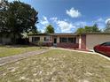 Well-kept home with lush landscaping, brick accents, and a side-entry garage at 120 Borada Rd, Sanford, FL 32773
