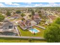 Aerial view of the home showcasing the expansive yard, swimming pool, and solar panels at 144 Pinewood Cir, Kissimmee, FL 34743