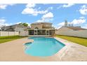 Backyard view of private swimming pool and screened patio, perfect for relaxation and outdoor entertainment at 144 Pinewood Cir, Kissimmee, FL 34743