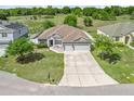 Beautiful home featuring a well-maintained yard and complemented by lush greenery at 1936 Bell Creek Loop, Fruitland Park, FL 34731
