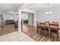 Open-concept dining room with wood floors, chandelier, and views of living spaces at 1936 Bell Creek Loop, Fruitland Park, FL 34731