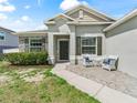 Inviting front entrance with brick pavers, seating, and decorative accents at 1936 Bell Creek Loop, Fruitland Park, FL 34731